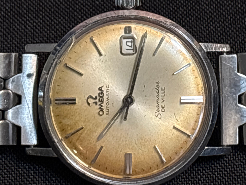 Omega Seamaster Deville date SS case on beads of rice bracelet.