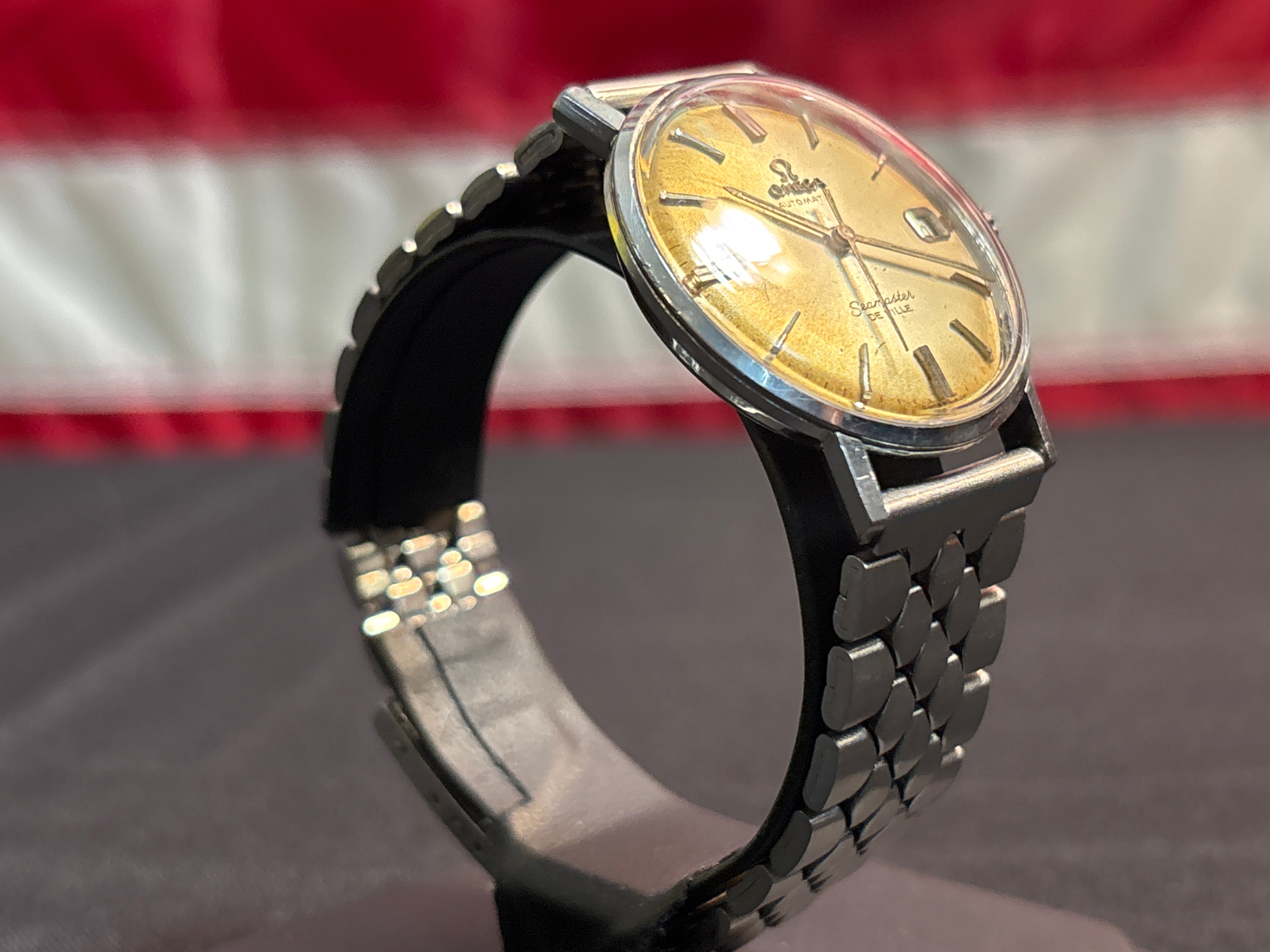 Omega Seamaster Deville date SS case on beads of rice bracelet.